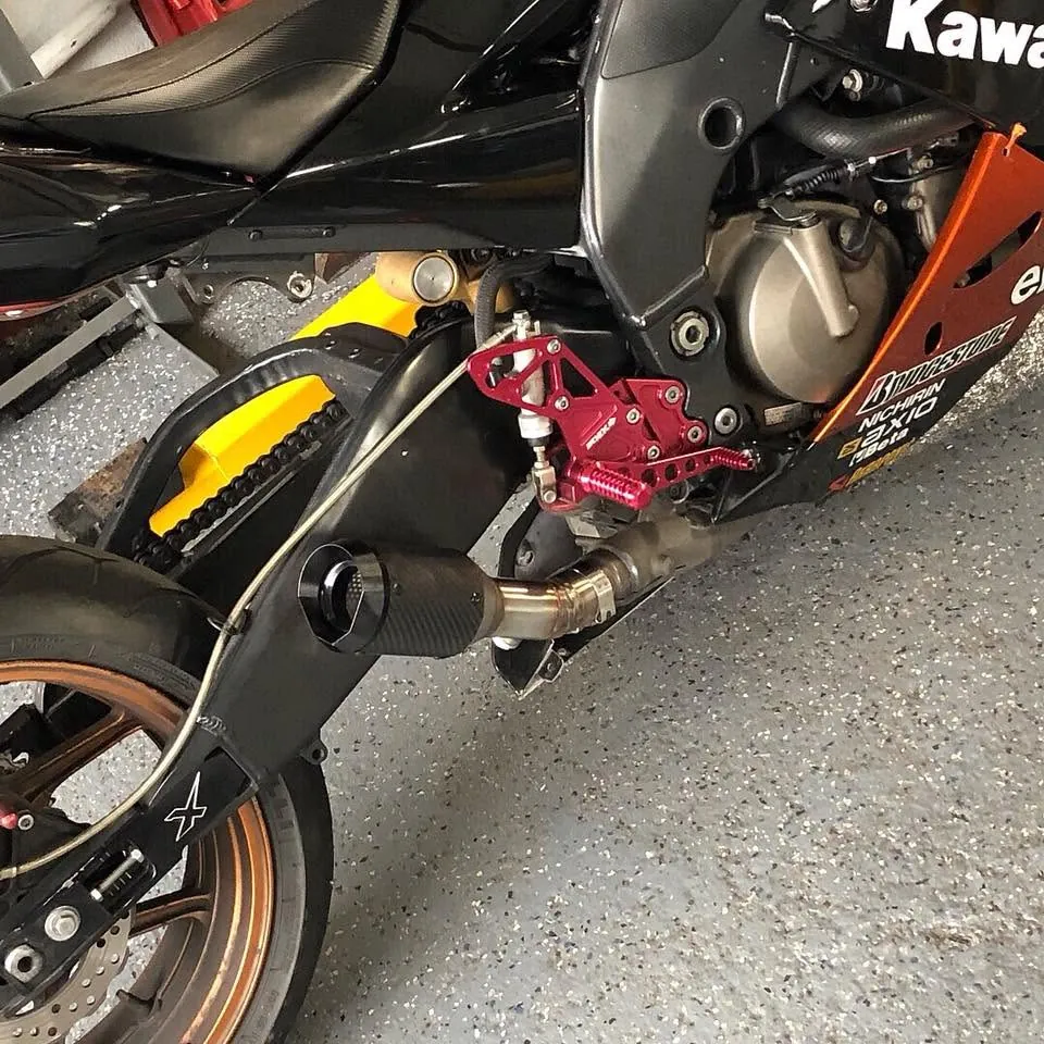 Custom exhaust mid-build on a Kawasaki track bike